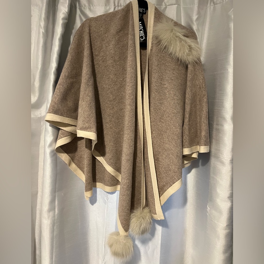 Pull thru wrap or poncho. Subtly accented with genuine fur trim